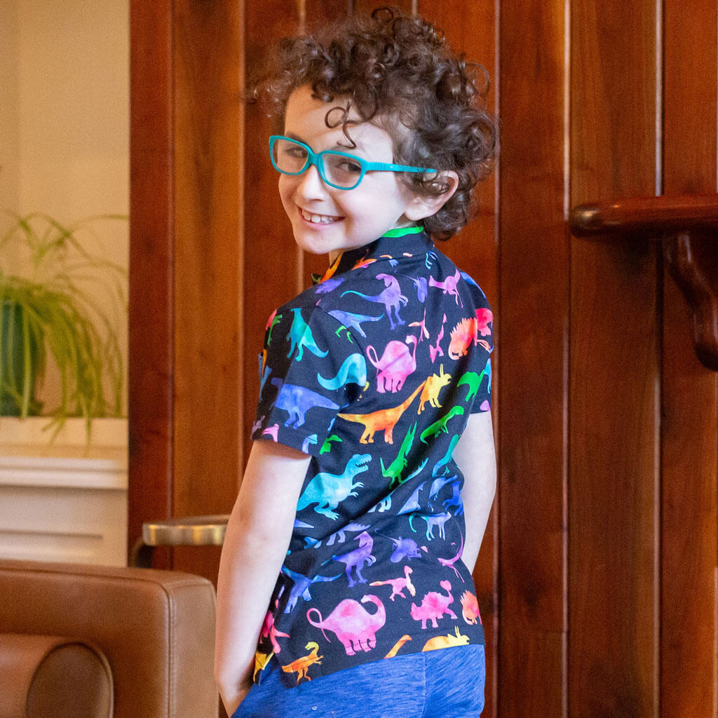 "Prehistoric Parade" Rainbow of Dinosaurs Short Sleeve Polo Shirt