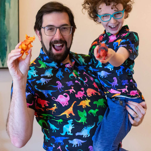 Adult "Prehistoric Parade" Rainbow of Dinosaurs Short Sleeve Polo Shirt