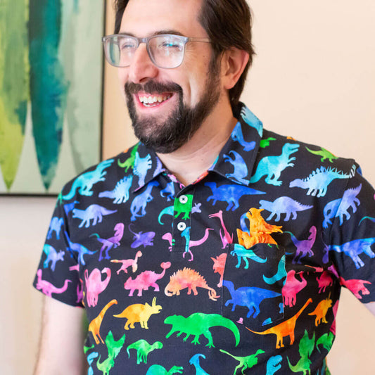 Adult "Prehistoric Parade" Rainbow of Dinosaurs Short Sleeve Polo Shirt